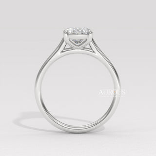 oval cut diamond gold band, custom oval diamond ring, modern oval engagement ring, oval cut diamond with side stones, oval diamond three stone ring, oval cut diamond ring setting, oval diamond prong setting, luxury oval diamond ring
