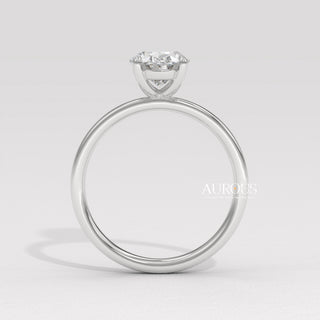 oval cut diamond gold band, custom oval diamond ring, modern oval engagement ring, oval cut diamond with side stones, oval diamond three stone ring, oval cut diamond ring setting, oval diamond prong setting, luxury oval diamond ring