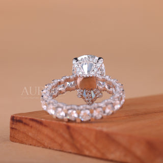 Rose gold and silver ring set on a wooden block with a beige background