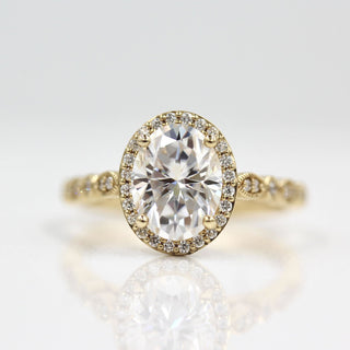 Vintage-inspired three-stone moissanite engagement rings with side stones