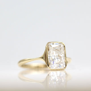 Vintage-inspired three-stone moissanite engagement rings under $1000